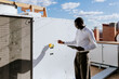© VICTOR TORRES/Stocksy - Engineer inspecting rooftop HVAC equipment on sunny day