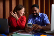 © Ivan Jovanovic/Stocksy - Colleagues sharing laughs at the office