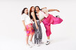 © María Soledad Kubat/Stocksy - Three young women smiling in colorful fashion studio portrait