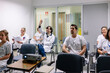© Daniel Gonzalez/Stocksy - Medical professionals attending seminar and asking questions