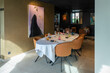 © Oksana - Extended dining arrangement. Large dining table partner with colorful art surroundings and elegant glassware