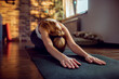 © Davor - Woman practicing child's pose on yoga mat at home