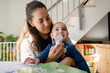 © Raul Navarro/Stocksy - Mother helping baby with asthma inhaler treatment
