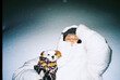 © Asya Molochkova/Stocksy - Quiet winter moment with a small dog under the night sky