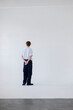 © OchreOchre/Stocksy - Man Standing, Back View In Striped Shirt