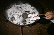 © Inna Reznik/Stocksy - Marshmallows Toast Over Fire at Outdoor Gathering With Friends