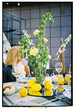© Asya Molochkova/Stocksy - Elegant Table Setting with Flowers, Lemons and Wine Glasses
