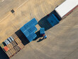© Lawren Lu/Stocksy - Aerial View of Worker with Blue Crates Loading Dock with Truck.