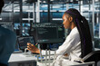 © DC Studio - Data center software developer using tablet, deploying and maintaining server and network hardware. African american woman in server hub using device to manage large scale IT infrastructure