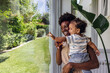 © VICTOR TORRES/Stocksy - Mother and child enjoying a moment by the window