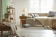 © New Africa - Beautiful sofa with knitted plaid and pillows in living room. Interior design