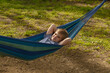 © Iryna Miadzvedzeva - Smiling boy relaxing in hammock outdoors on sunny summer day