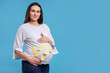 © New Africa - Pregnant woman with notes with different names on her belly against light blue background, space for text