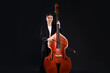 © New Africa - Girl with double bass and bow on black background