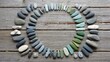 © Lim - Circular arrangement of polished pebbles and stones on weathered wooden planks showcasing natural beauty