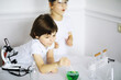 © alexkich - Two cute children at chemistry lesson making experiments on white background