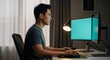 © Николай Срибяник - Focused Asian man coding on computer in dark home office.