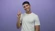 © Krakenimages.com - Young hispanic man holds up victory sign with hand against purple studio wall; peace joy happiness optimism.