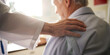 © MD - A caring hand from a medical professional rests reassuringly on the shoulder of an elderly patient
