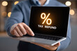 © menon - Tax refund percentage displayed on laptop screen office setting digital content modern environment close-up view