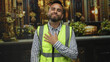 © Krakenimages.com - Young hispanic man in reflective safety vest placing hand on chest in a church building; faith gratitude.