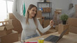 © Krakenimages.com - Young woman dancing joyfully in her new apartment among moving boxes, embodying happiness and accomplishment as she adapts to her new living space.