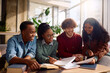 © Drazen - Group of happy diverse students learning together at university.
