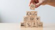 © Svyatoslav Lypynskyy - Hand Stacking Wooden Blocks with Wellness Icons