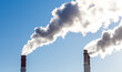 © Dmitry Presnyakov - CHP emissions. Smoking chimney releasing smoke against a blue sky. Smoke from factory pipe of heat station in the city. Air pollution. Nuclear power plant cooling. CO2, greenhouse gases emissions.