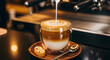 © IMON - Coffee being poured into a glass cup on a saucer with cookies