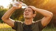 © Premium - Exhausted Man Pouring Water on Face After Outdoor Workout in Summer Heat