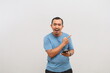 © ArvStd - Amazed Asian man holding smartphone and pointing aside at copy space isolated over white background