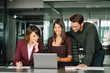 © Stock 4 You - Group of young mature business people partners having conversation discussion using laptop sitting in office. Woman manager showing finance project online, doing training to job coworkers, colleagues