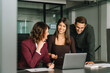 © Stock 4 You - Young woman manager showing finance project online, doing training to job coworkers, colleagues. Group of mature business people partners having conversation discussion using laptop sitting in office