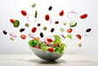 © Evgeniya Uvarova - Fresh salad ingredients including tomatoes, cucumbers, olives, and feta flying into white bowl. Dynamic food splash for health, wellness, and restaurant advertising.
