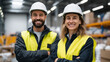 © Maksym - Professional lifestyle portrait of factory workers in safety helmets and reflective vests standing confidently in a spacious warehouse, smiling man and woman front and center, natu