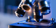 © Parilov - Close-up of microscope lenses focusing on slide in laboratory setting