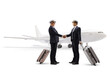 © Ljupco Smokovski - Two pilots with suitcases shaking hands in front of a plane