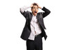 © Ljupco Smokovski - Stressed man in a ruined suit holding his head and shouting