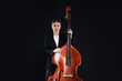 © New Africa - Girl with double bass on black background
