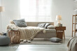 © New Africa - Beautiful sofa with knitted plaid and pillows in living room. Interior design