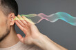 © New Africa - Hearing health. Man with audio waves coming to his ear on grey background, closeup