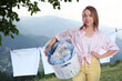 © New Africa - Happy woman with laundry basket in mountains