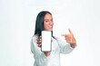 © Ryan - A smiling Indonesian woman in a white shirt showcasing a smartphone with a blank white screen mockup, pointing to it against a white background.