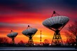 © kardaska - Radio telescropes capturing signals during colorful sunset