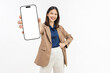 © sitthiphong - Cheerful young Asian businesswoman holding a smartphone with blank screen and smiling confidently isolated on white studio background for mobile app.