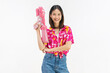 © sitthiphong - Songkran festival in Thailand, Cheerful young woman wearing summer wearing floral shirt with a pink water gun isolated on white background.