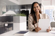 © fizkes - Portrait of smiling woman, staff member, office employee using tablet seated at desk in modern workplace, performing administrative task remotely, planning project plan, prepare presentation, portrait