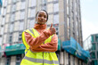 © Iryna - Construction worker shows thumbs up for project progress at building site in city during daytime