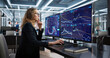 © Andrey Popov - Female Broker Analyzing Data On Multiple Screens